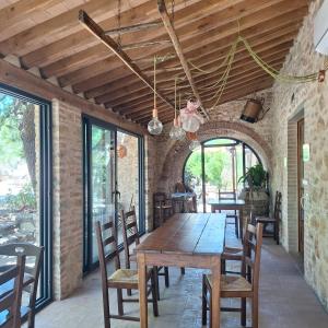 a dining room with a wooden table and chairs at Agriturismo Salaiolo 176 in Scansano +10 photos