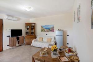 a living room with a couch and a table at Prima Luce in Vico Equense