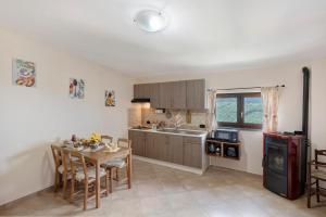a kitchen with a table and a dining room at Prima Luce in Vico Equense +21 photos