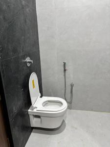 a bathroom with a white toilet in a stall at HOTEl SHREE ASHTVINAYAK GRAND in Mandlā