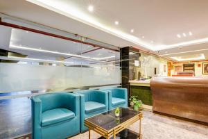 a restaurant with blue chairs and a table at The IVY Grand Hotel - 5 Minutes from Connaught Place and New Delhi Railway Station With Free Secured Parking in New Delhi