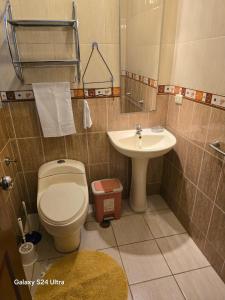 a bathroom with a toilet and a sink at DEPARTAMENTO en AREQUIPA JOSE LUIS BUSTAMANTE in Arequipa +14 photos