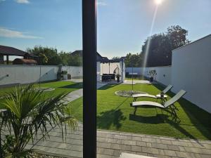 a view of a garden with a bench on a patio at Apartman NOA in Slavonski Brod