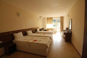 a hotel room with two beds in a room at Hotel Marant in Sozopol