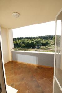a room with a large window and a tile floor at Hotel Marant in Sozopol