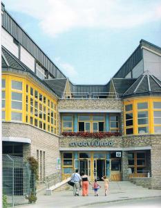 a group of people walking in front of a building at Termál Apartman in Tiszaújváros +20 photos