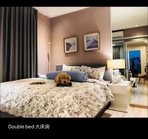 a dog laying on a bed in a bedroom at Maya Ninman area 2 bedrooms Condo in Chiang Mai +16 photos