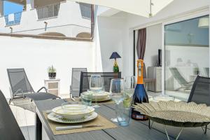 a dining room with a table with plates and glasses at Villa Ada in Golfo Aranci