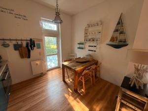 a kitchen with a wooden table and a dining room at Küstenloft-Leuchturm in Rostock +23 photos
