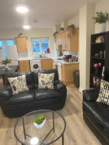 a living room with a black couch and a glass table at Super Central Location Private R3 in Dublin