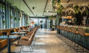 a row of tables and chairs in a restaurant at Lifesteil Aparthotel in Umhausen