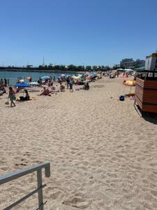 a group of people on a beach with the water at Апартаменты в 5 минутах от моря, пляж Черноморка, Одесса in Odesa