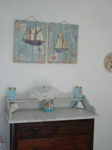 a wooden cabinet with a stained glass window on a wall at Sikinos Best View in Alopronia