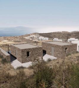a group of stone buildings on top of a hill at Piperi Suites in Kithnos +45 photos
