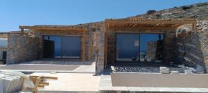 a house being constructed with glass windows on it at Piperi Suites in Kithnos