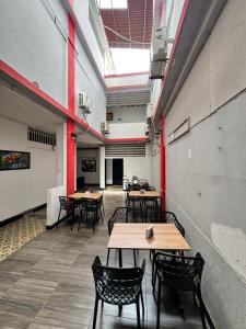 a room with tables and chairs in a building at Hotel Sion Real in Neiva +15 photos
