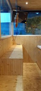 an empty sauna with a wooden floor and a window at Syamantac Villa in Kodaikānāl +105 photos