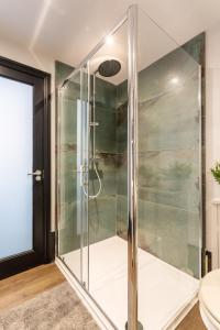 a glass shower in a bathroom with a toilet at Fun Kemptown Stay with Games Close To Seafront in Brighton & Hove