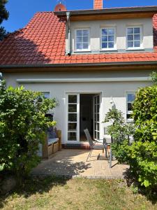 a white house with a red roof at Haus Lykkelig in Zingst