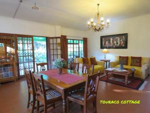 a dining room and living room with a table and chairs at Touraco in Hogsback