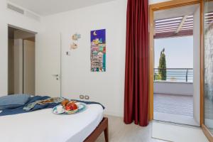 a bedroom with a bed with a plate of fruit on it at Portopiccolo Apartments in Sistiana