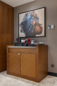 a painting of a woman is hanging on a wall at Hilton Istanbul Maslak in Istanbul