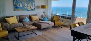 a living room with a couch and a table at Himmel & Meer Suite in Timmendorfer Strand