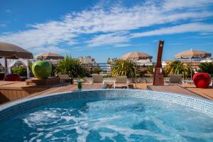 a swimming pool on the roof of a hotel at Best Western Premier Le Patio des Artistes Wellness Jacuzzi in Cannes
