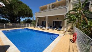 a swimming pool in front of a house at Atanasio by Check-in Portugal in Albufeira