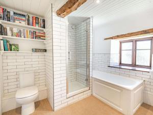 a white bathroom with a toilet and a sink at 5 Bed in Kendal 88095 in Skelsmergh +25 photos