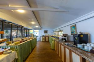 a restaurant with a long line of counters and tables at Kulube Hotel in Kalkan