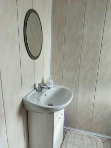 a bathroom with a sink and a mirror at Sielankowy Domek in Istebna +20 photos