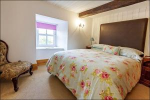 a bedroom with a large bed and a window at Betws Bach in Criccieth