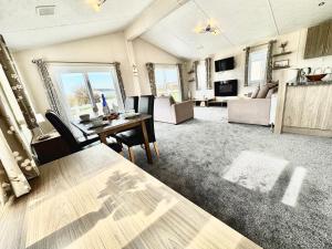 a large living room with a table and chairs at Seaside Escape - Parkdean Resort Camber Sands in Camber +16 photos