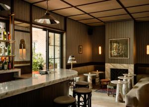 a bar in a restaurant with a fireplace at The Nickel Hotel in Charleston