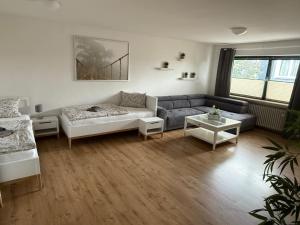 a living room with a couch and a table at Fewo 2 in Nortorf