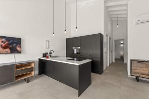 a kitchen with black cabinets and a sink at Tropical Escape - CBW366 - 8 in Jan Thiel