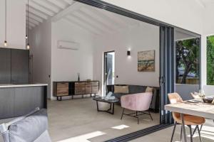 a kitchen and a living room with a table at Tropical Escape - CBW366 - 8 in Jan Thiel