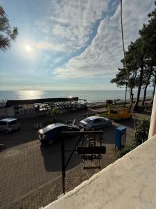a group of cars parked in a parking lot near the ocean at seaside 56 in K'obulet'i +32 photos