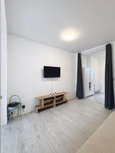 a living room with a flat screen tv on the wall at Spacieux appartement une chambre in Brussels +1 photo