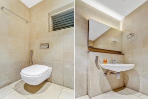 a bathroom with a toilet and a sink at Hotel Karpagam Lodging House Nr Railway Station & Gandhipuram bus stand in Coimbatore +20 photos