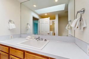 a bathroom with a sink and a large mirror at Belfair Bliss in Belfair