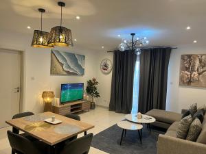 a living room with a couch and a table at Loxwood by Tripview Apartments in Accra