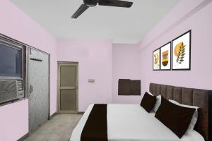 a bedroom with a bed and a television in it at Hotel O Shree Shyam Guest House in Noida
