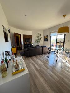a living room with a couch and a table at Piemont Flat Apart in Serra Negra +28 photos