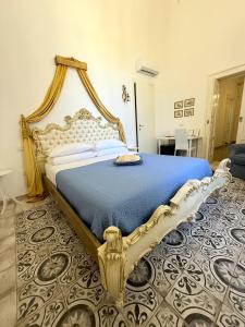 a bedroom with a large bed with a blue bedspread at DONNA LUCREZIA b&b Boutique Hotel Style - RELAX & BUSINESS STAY in Bisceglie