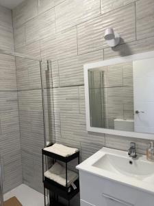 a white bathroom with a sink and a mirror at Casa San Pedro in San Pedro del Pinatar
