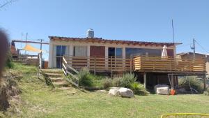 a house on a hill with a fence in front of it at Vista los Andes in Cacheuta