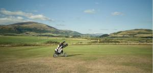 a motorcycle is parked on a golf course at The Mayflower in Millom