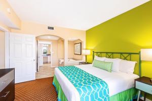 a hotel room with a bed and a bathroom at Vacation Village at Weston, Fort Lauderdale in Weston